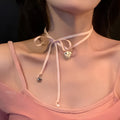 Women's alloy fashion necklace with ribbon design and a love pendant on a clavicle chain.