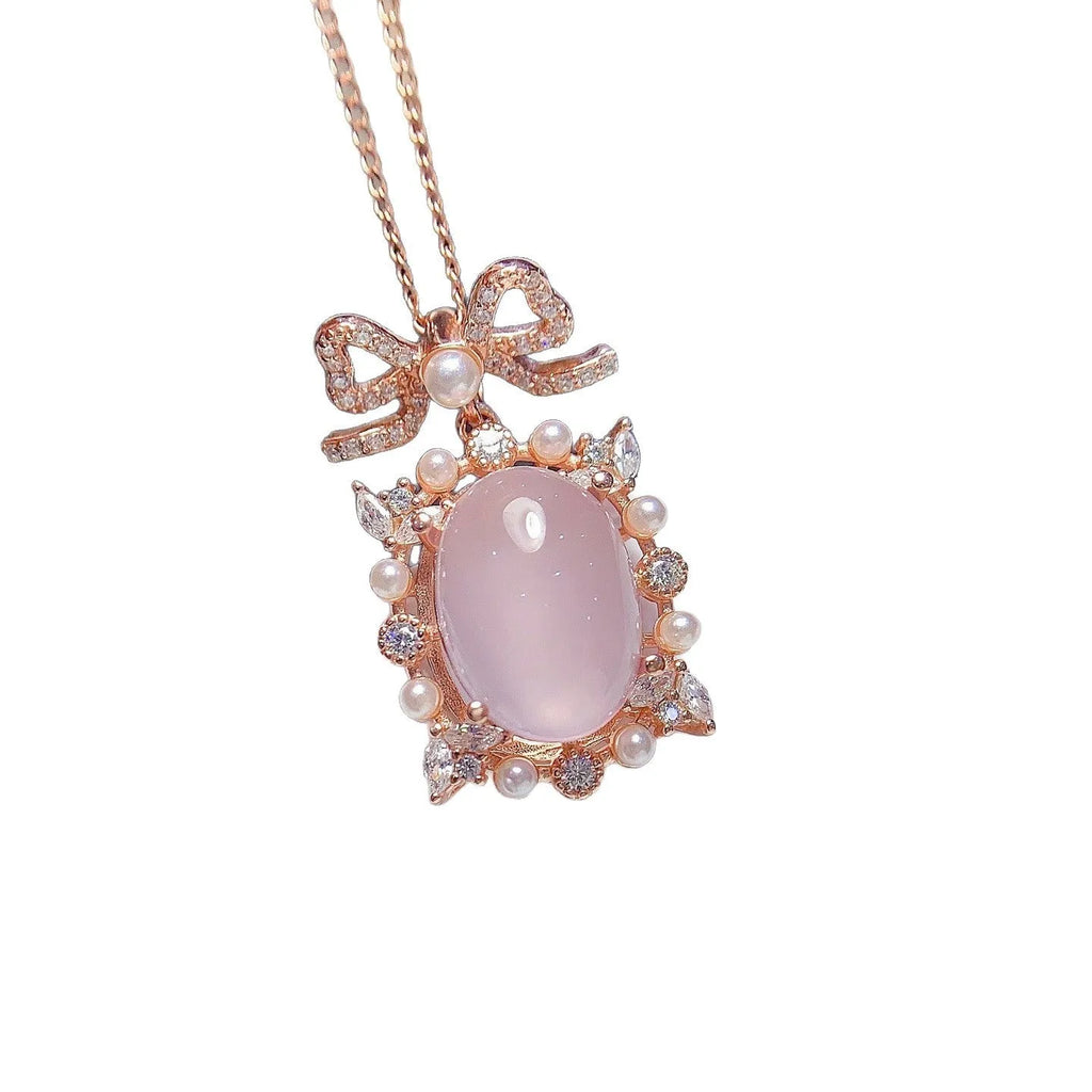 Pink crystal rose quartz pendant with rose gold plated geometric setting on alloy necklace