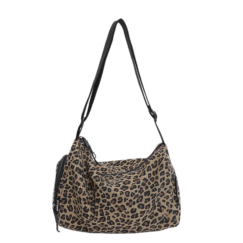 Leopard print sports style messenger bag with cross-body strap and decorative stitching