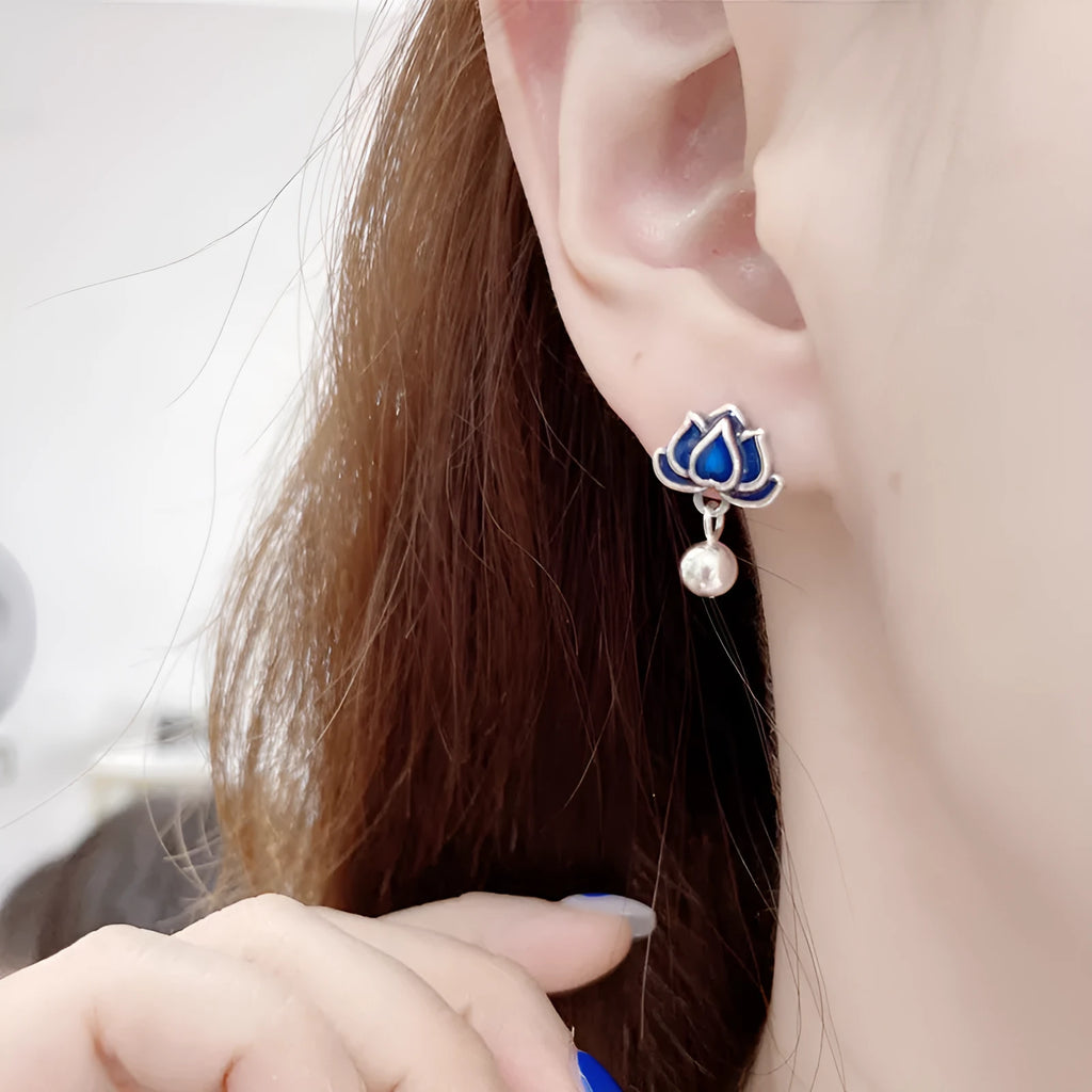 Blue alloy lotus earrings with seedpod tassel detail, showing floral stud design.