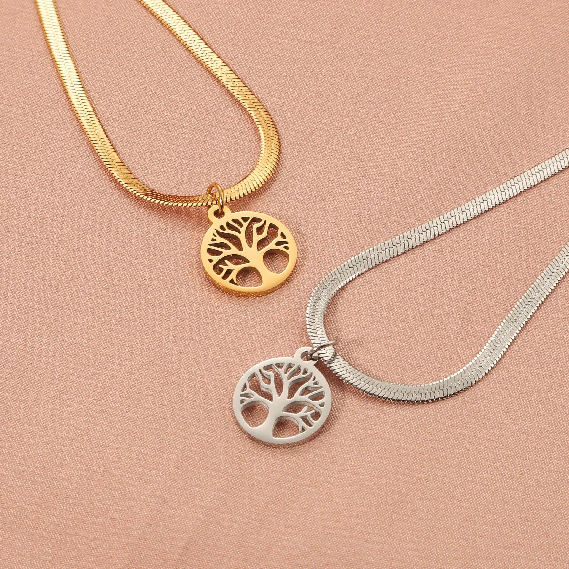 Stainless steel lucky tree necklace on snake bones chain, shown in gold and steel colour finishes.