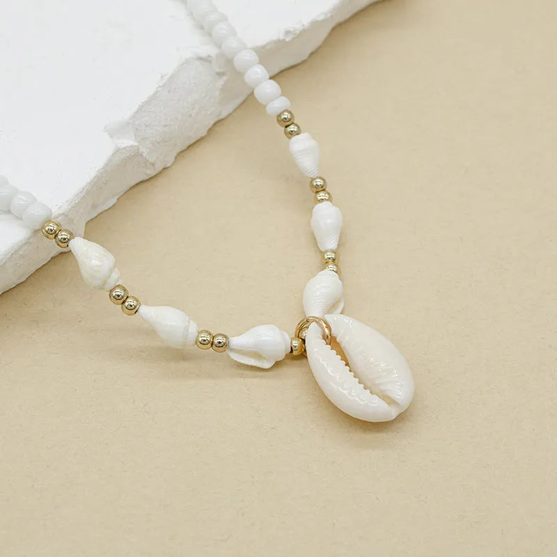 White conch shell bead necklace with mother of pearl pendant on regular chain