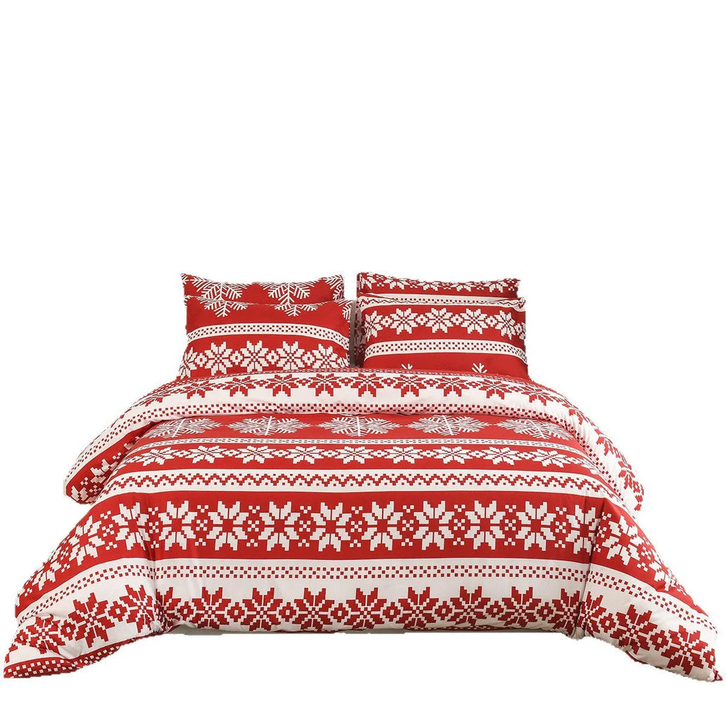 Red Christmas Love Song pattern bed cover-style quilt and pillowcases on a bed.