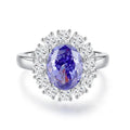 Heart-shaped 925 sterling silver ring with a sparkling ice flower cut colour zircon stone on a finger.