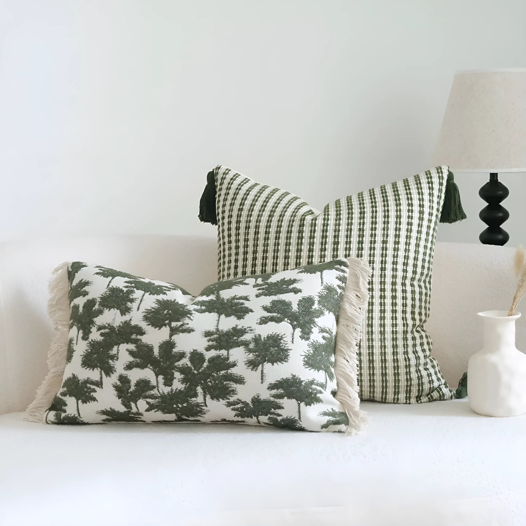 Green striped and botanical patterned cotton linen decorative pillow with tassel detail.