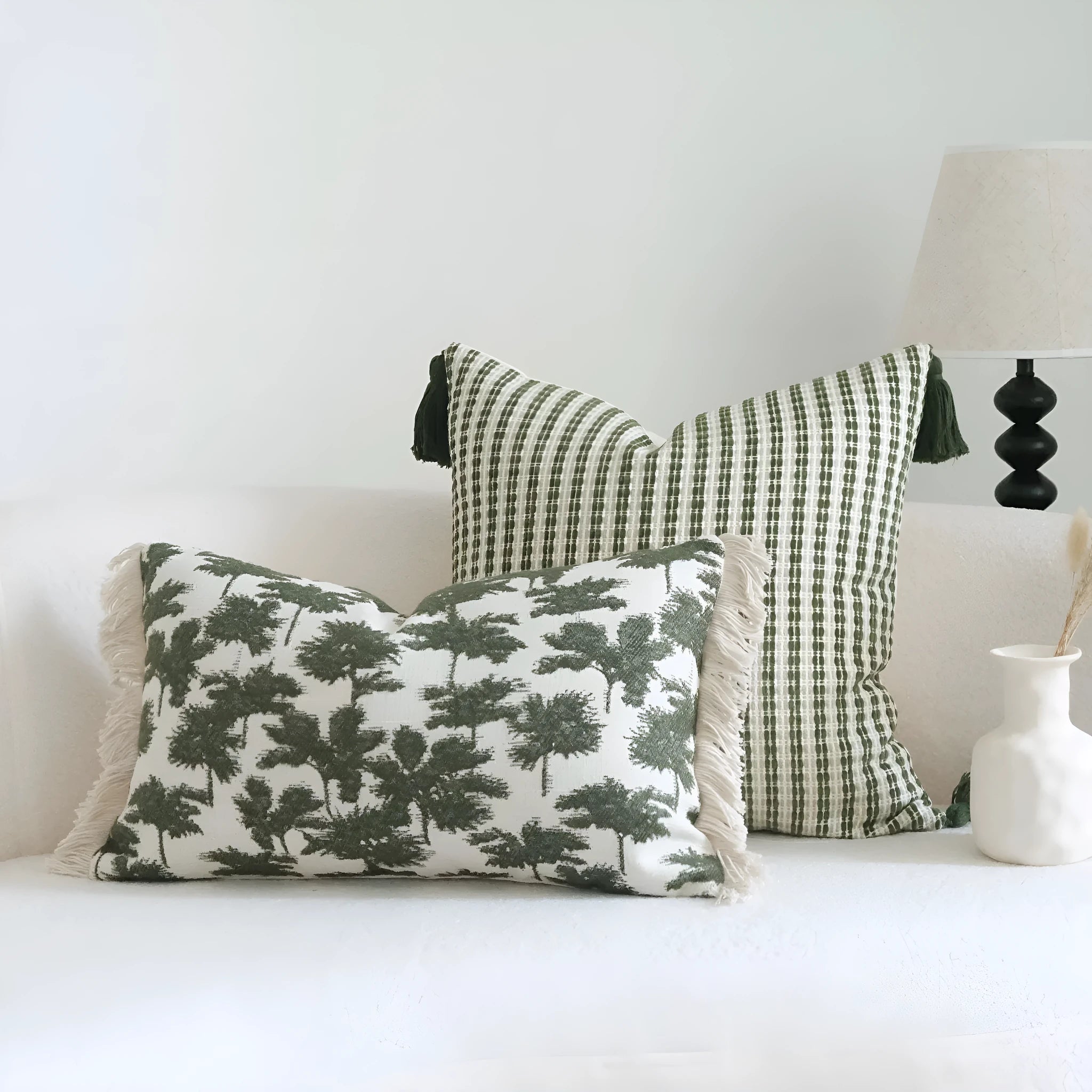 Green striped and botanical patterned cotton linen decorative pillow with tassel detail.