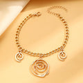 Geometric spiral donut jewellery set with gold necklace, bracelet, and ear hooks on dark background