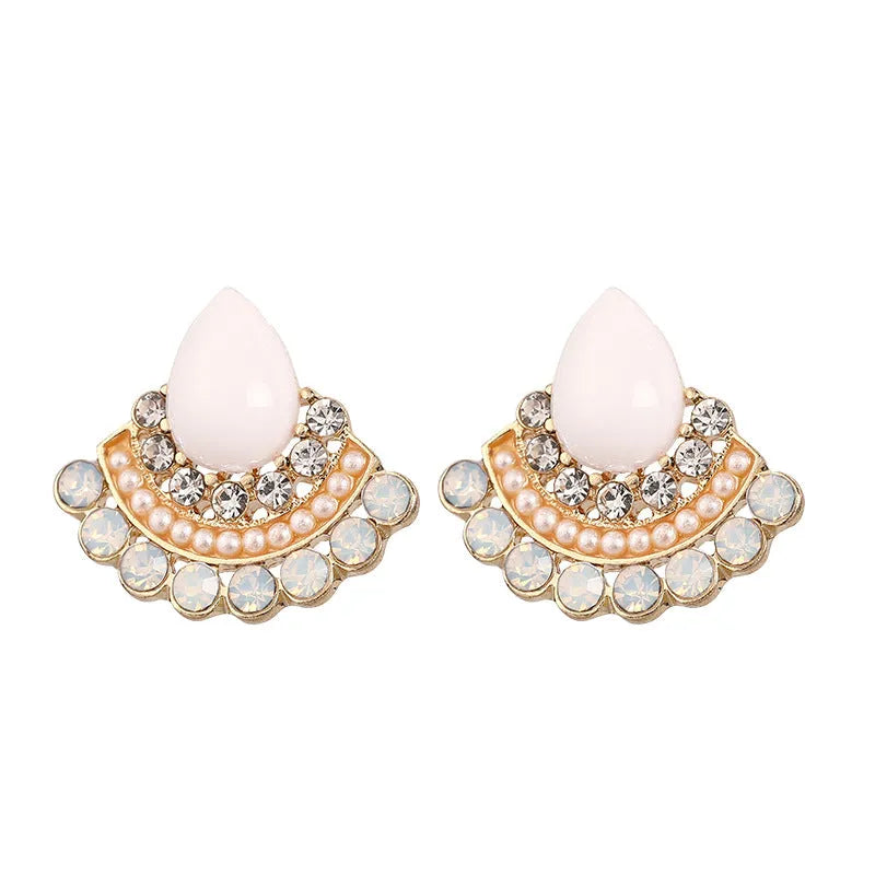 Silver fan-shaped geometric stud earrings with rhinestone detailing on white background