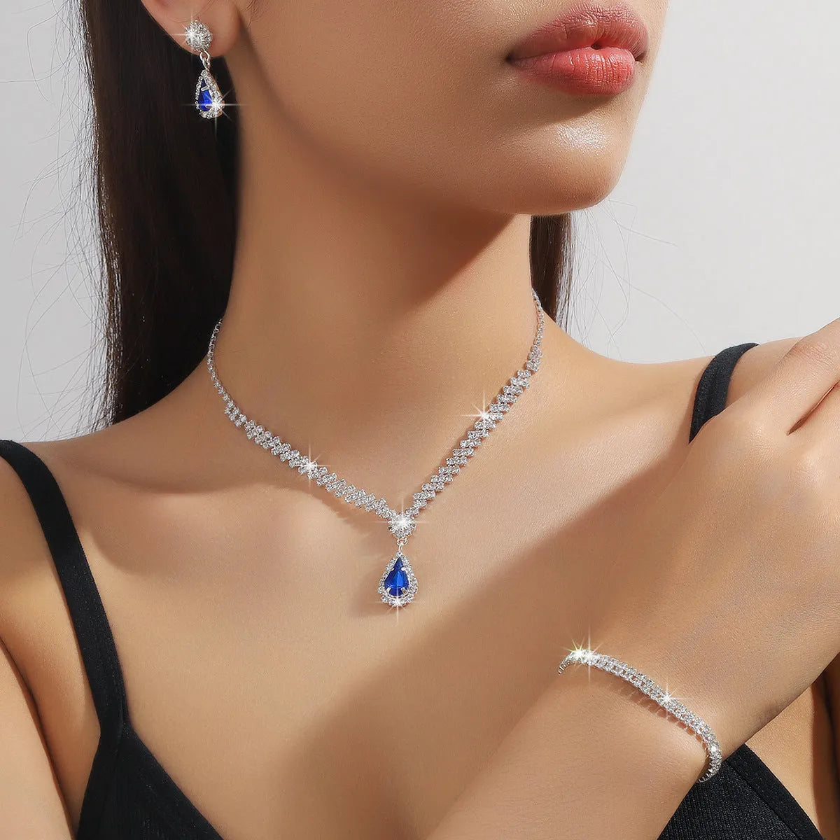 Claw chain necklace and matching earrings set with water drop rhinestone design in multiple colours
