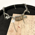 Dark multi-layer women's necklace with twin clavicle chains and large hemp flower links, adjustable between 41cm and 50cm.