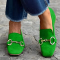 Green suede women's loafers with a round toe, metal fastener, and flat rubber sole.