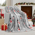 Soft flannel Christmas blanket in a plush fabric, shown in one of five available colours, draped over a sofa.