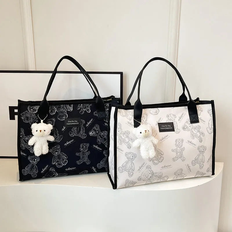 Women's printed canvas tote bag with diamond pattern, sandwich pocket, and shoulder strap