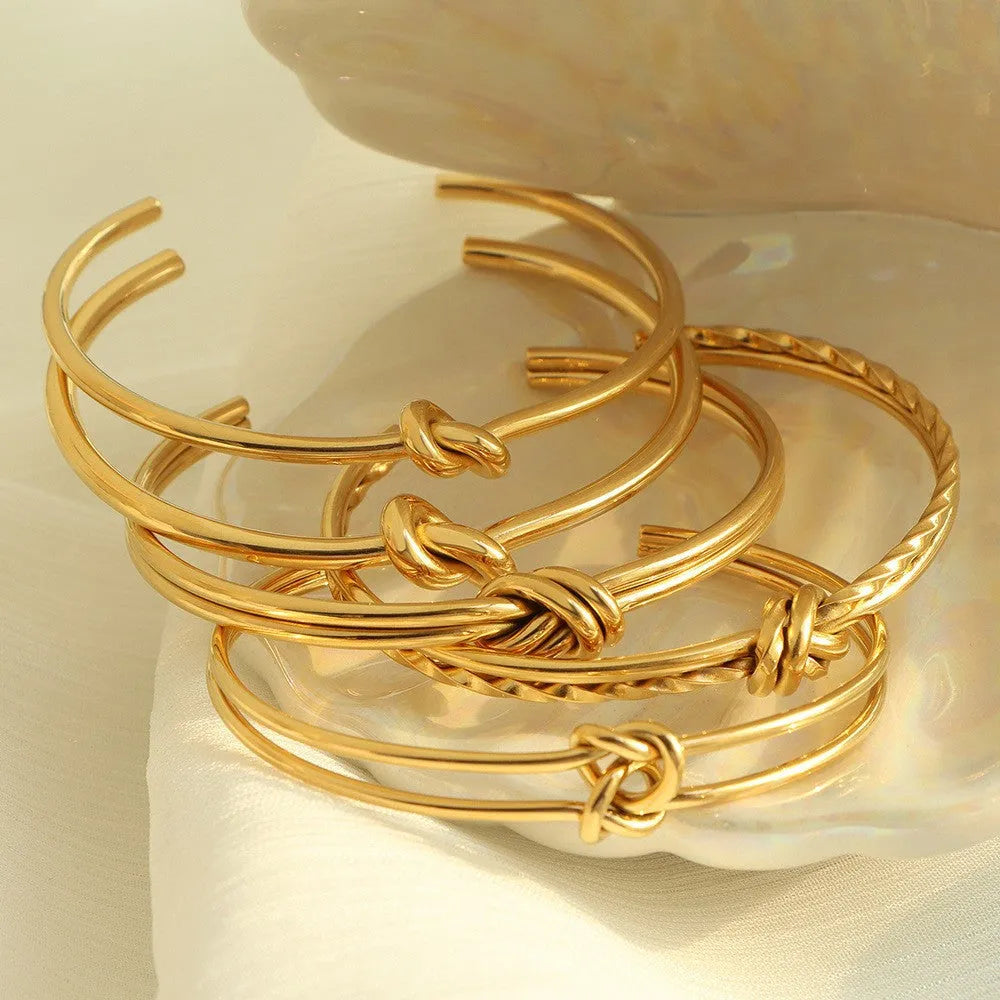 Gold or silver adjustable women's bracelet with knotted C-shaped open design and double layers.