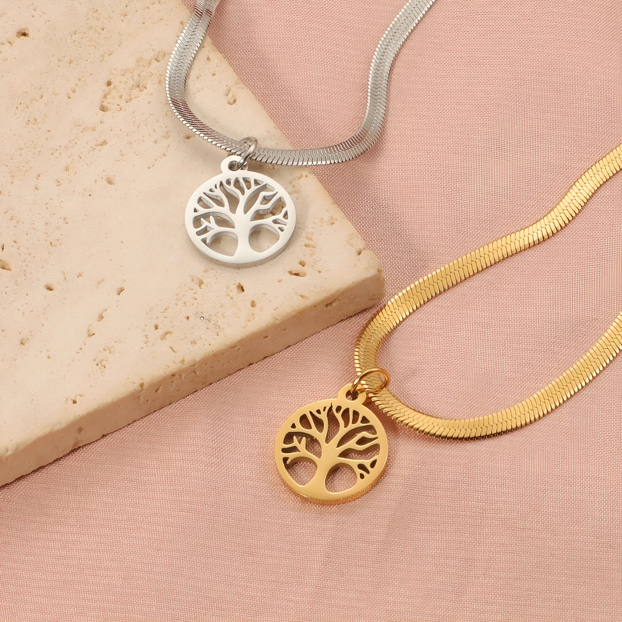 Stainless steel lucky tree necklace on snake bones chain, shown in gold and steel colour finishes.