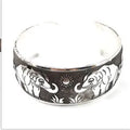 Ethnic carved open bracelet with Miao silver style in turtle colour showing Roman-inspired shape