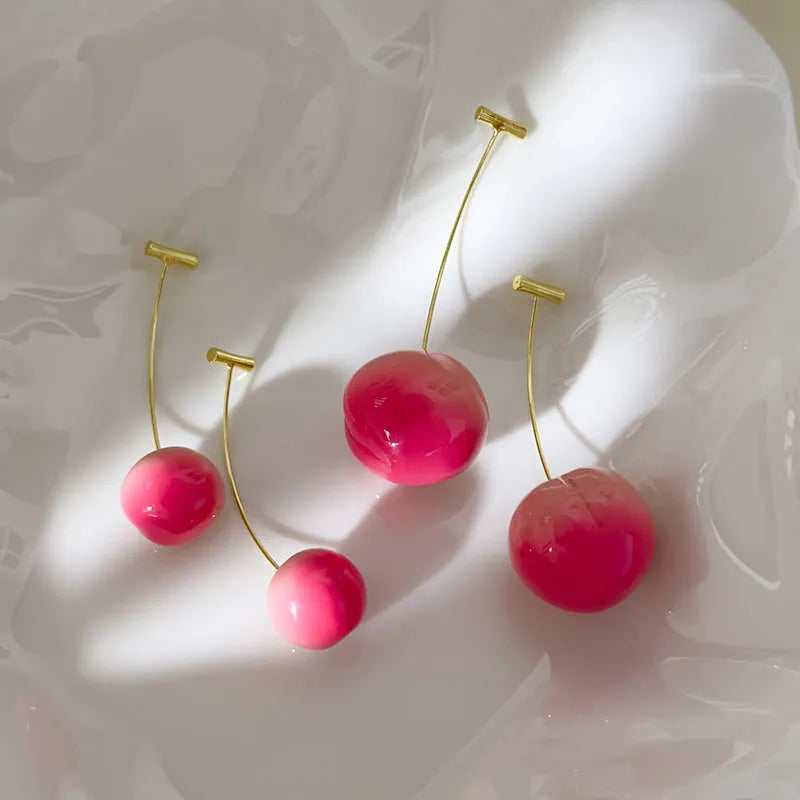 Small and large acrylic peach fruit earrings with copper hooks showing realistic peach detailing