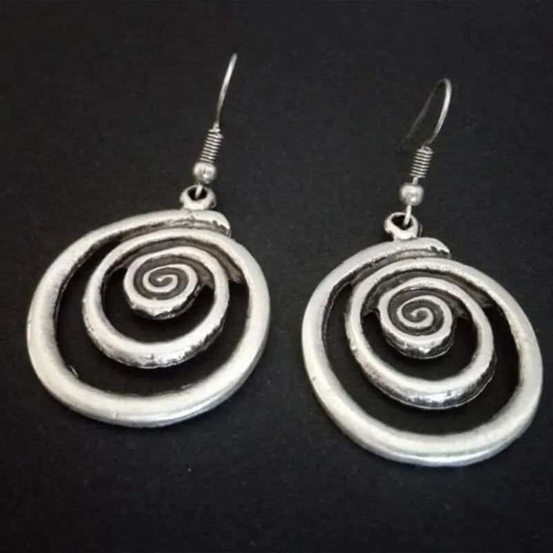 Silver geometric spiral distressed earrings measuring 2.6cm by 5cm with alloy construction