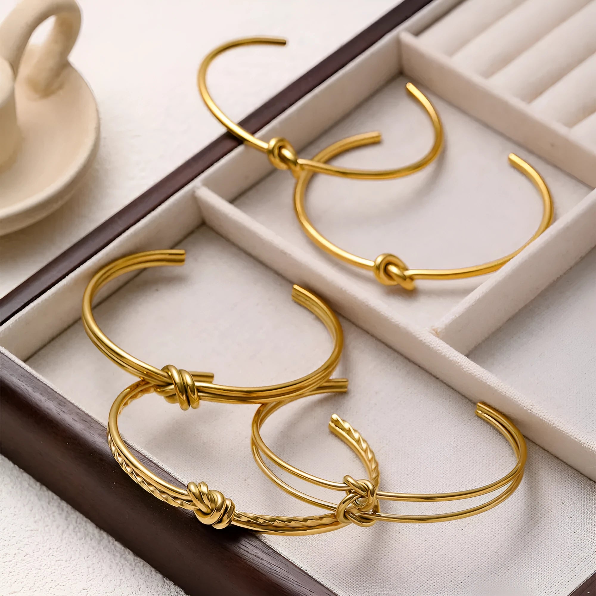 Gold or silver adjustable women's bracelet with knotted C-shaped open design and double layers.