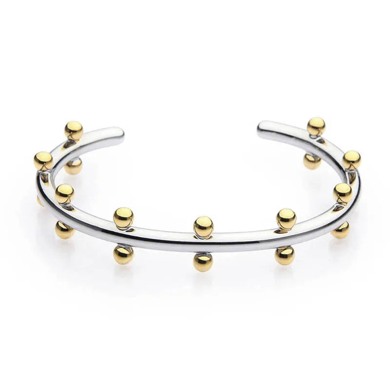 Stainless steel alloy C-shaped bracelet with textured rivet design and bean beads on an adjustable clasp.