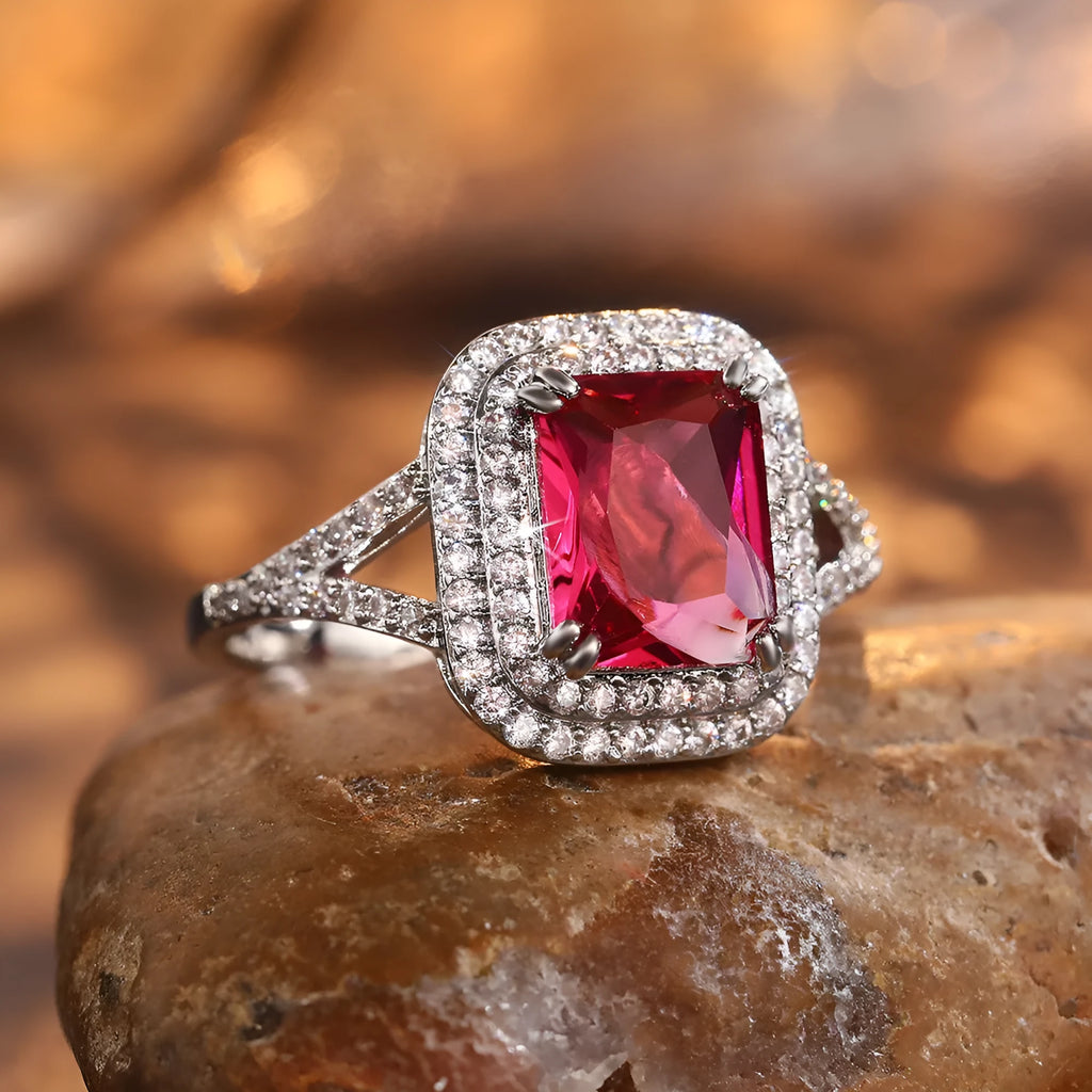Geometric square copper women's ring with a red rhinestone, shown on a finger.