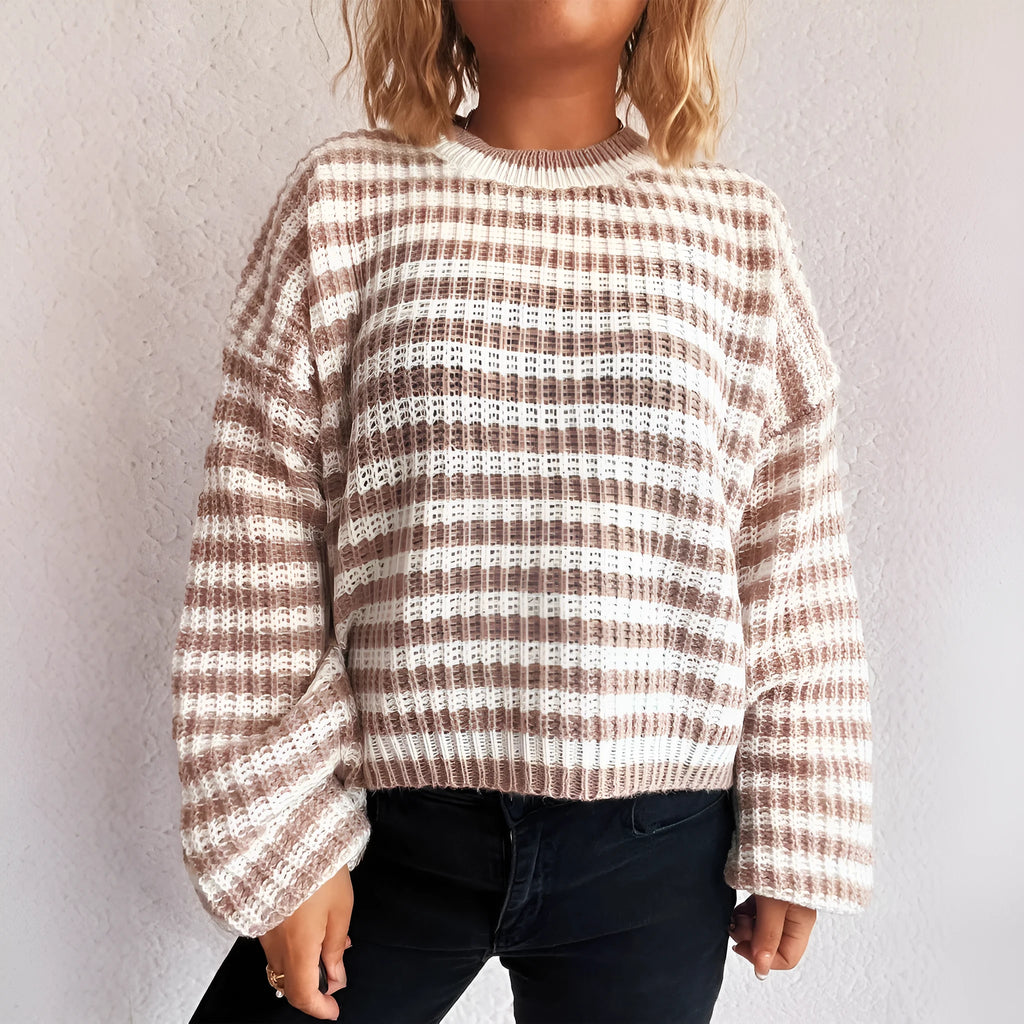 Women's black and white striped loose-fit pullover sweater with long sleeves and a round neck.