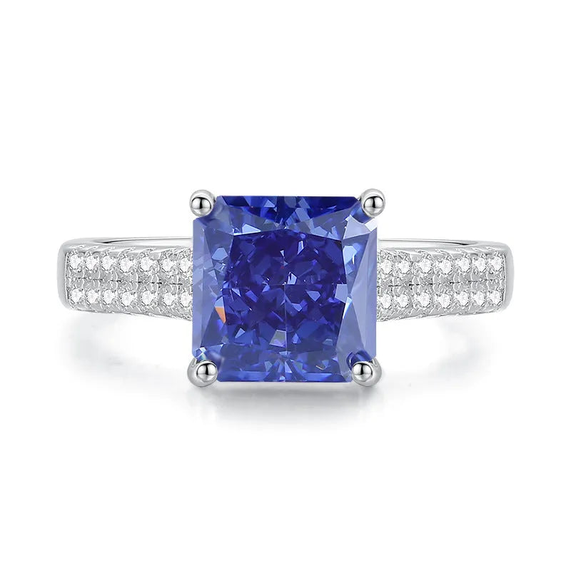 Heart-shaped 925 sterling silver ring with a sparkling ice flower cut colour zircon stone on a finger.