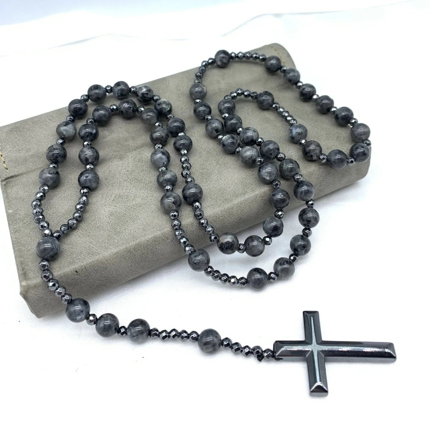 Men's hand-woven stone cross pendant necklace on a ball bead chain with safety lock clasp.