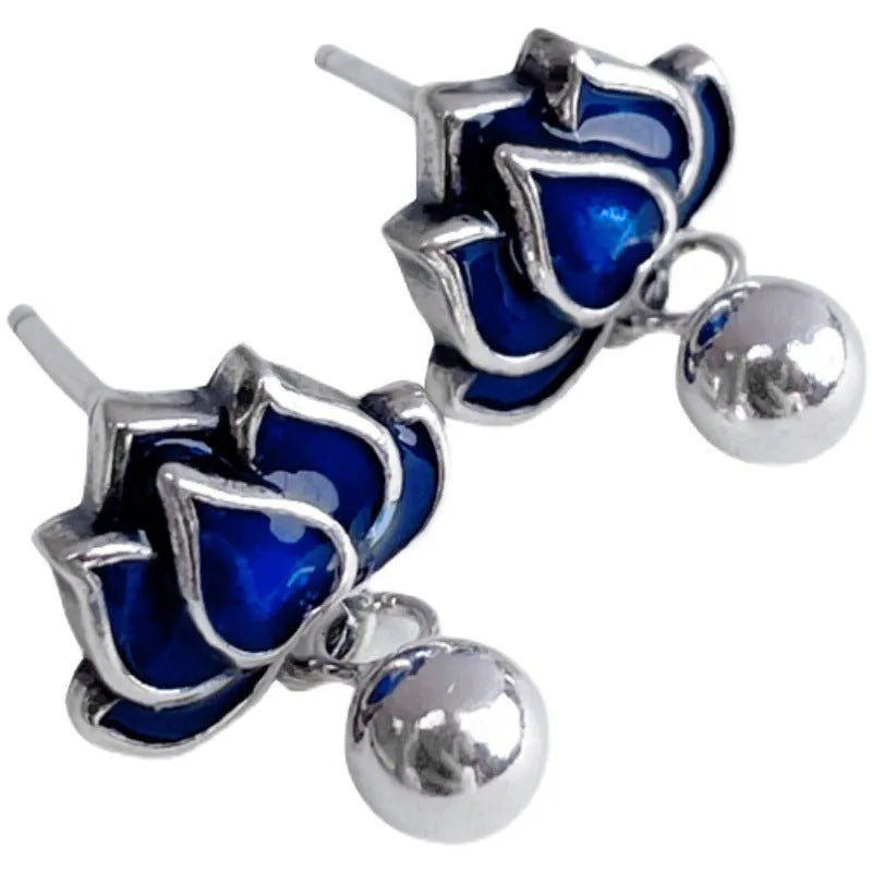 Blue alloy lotus earrings with seedpod tassel detail, showing floral stud design.