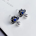 Blue alloy lotus earrings with seedpod tassel detail, showing floral stud design.