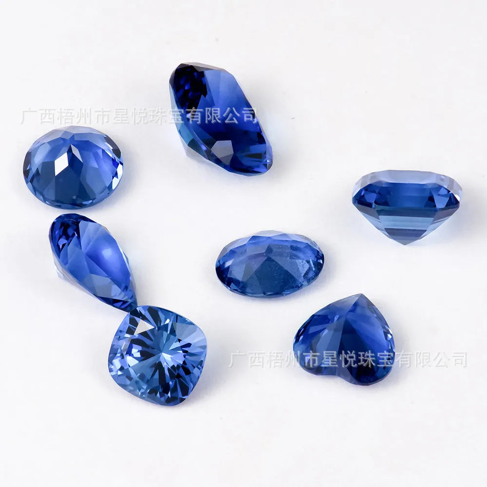 A royal blue loose gemstone with a precision cut, shown against a neutral background.