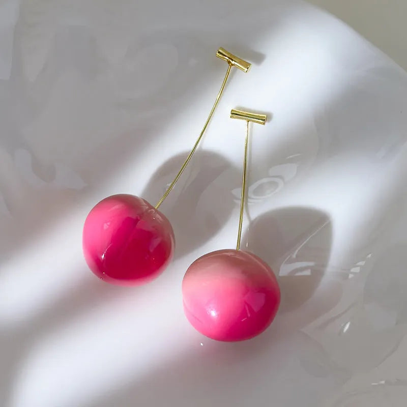 Small and large acrylic peach fruit earrings with copper hooks showing realistic peach detailing