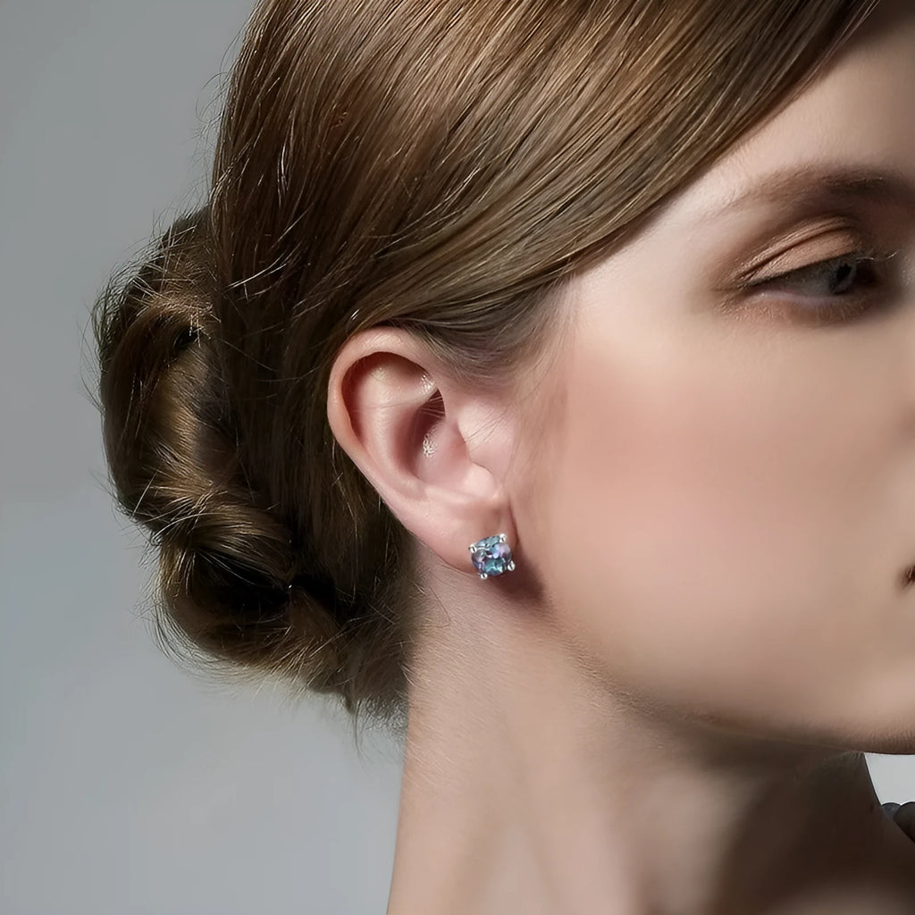 A pair of simple geometric ear studs for women in cultivated Alexandrite colour, made from 925 silver.
