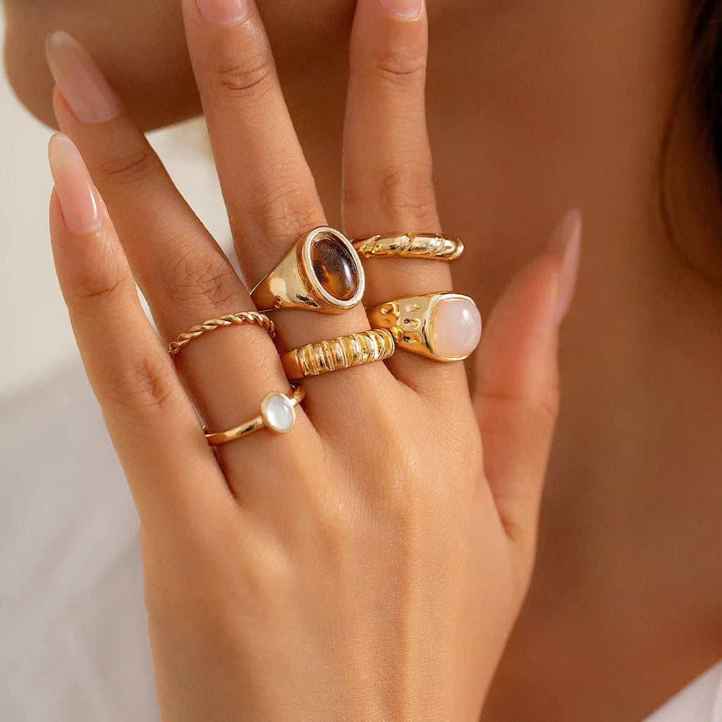 Set of six light gold geometric alloy rings with irregular shapes and electroplated finish