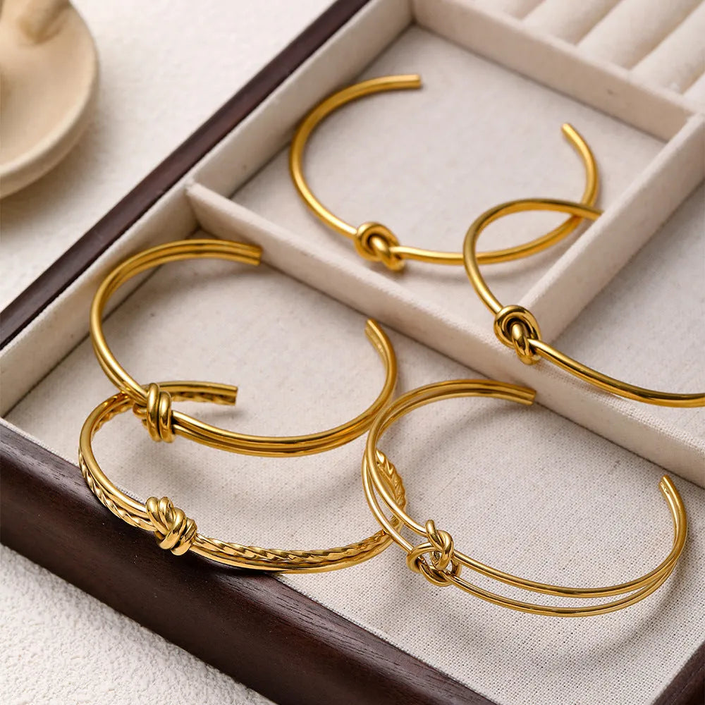 Gold or silver adjustable women's bracelet with knotted C-shaped open design and double layers.