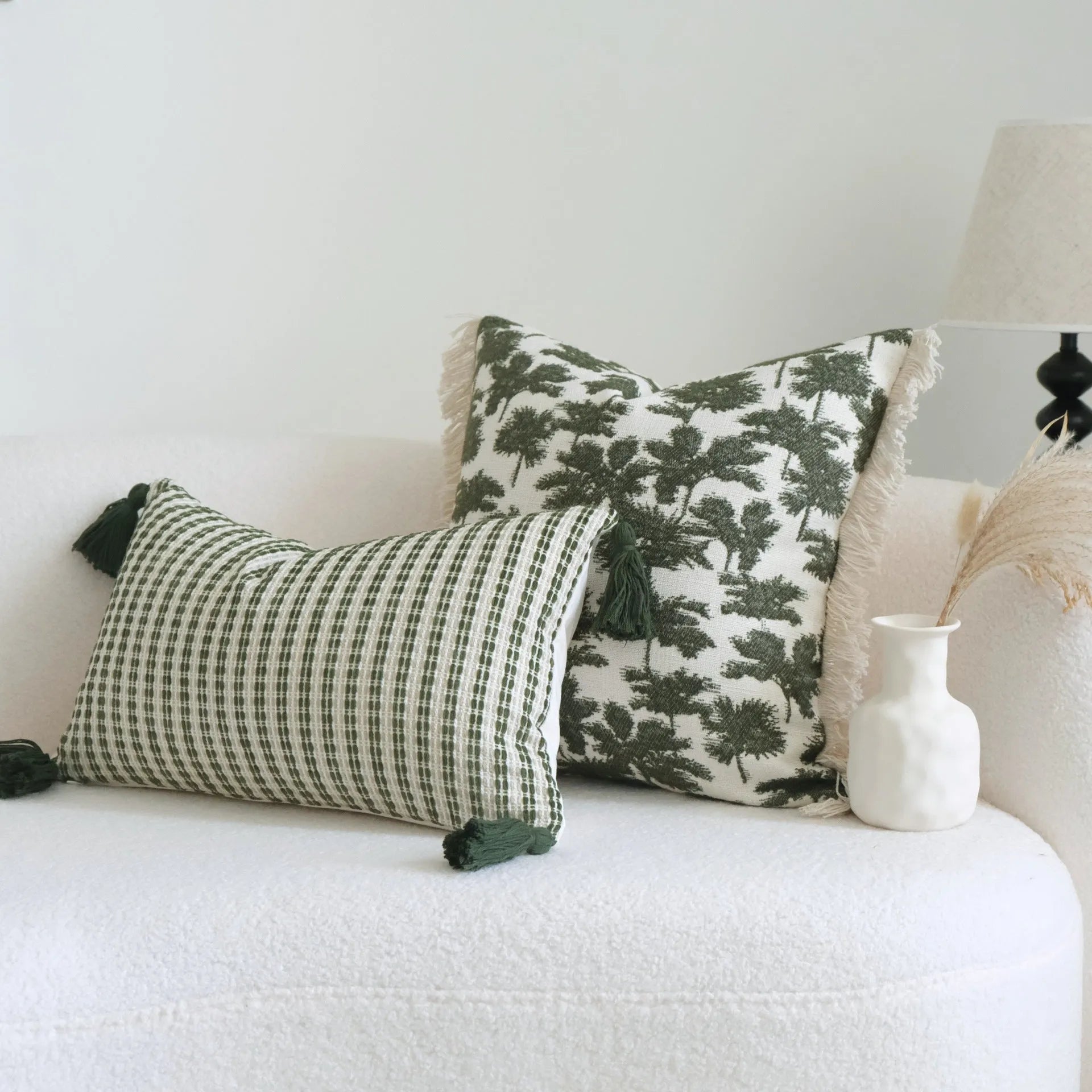 Green striped and botanical patterned cotton linen decorative pillow with tassel detail.