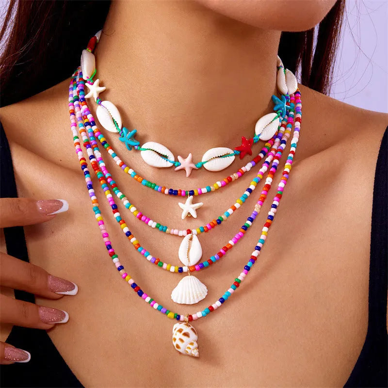 Women's multi-layer necklace set with starfish, shell and conch bead pendants in blue