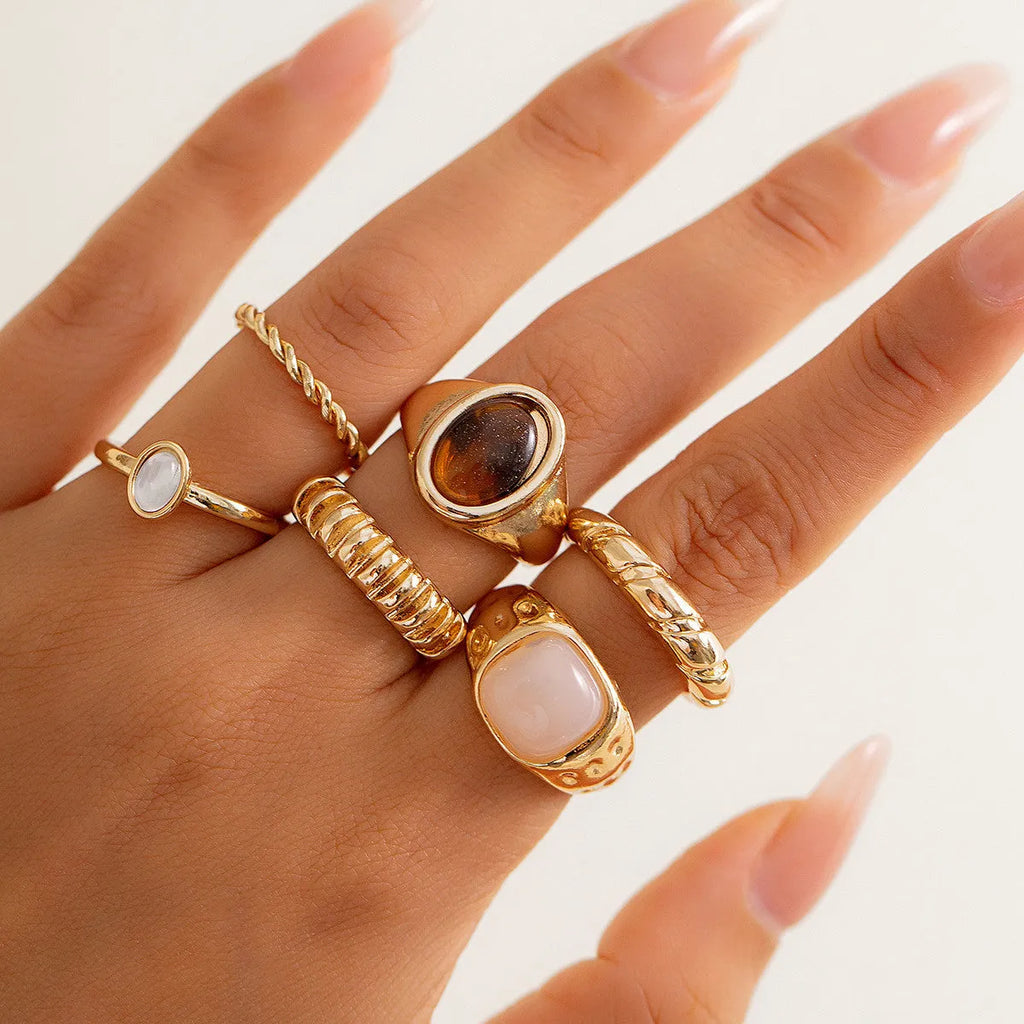 Set of six light gold geometric alloy rings with irregular shapes and electroplated finish
