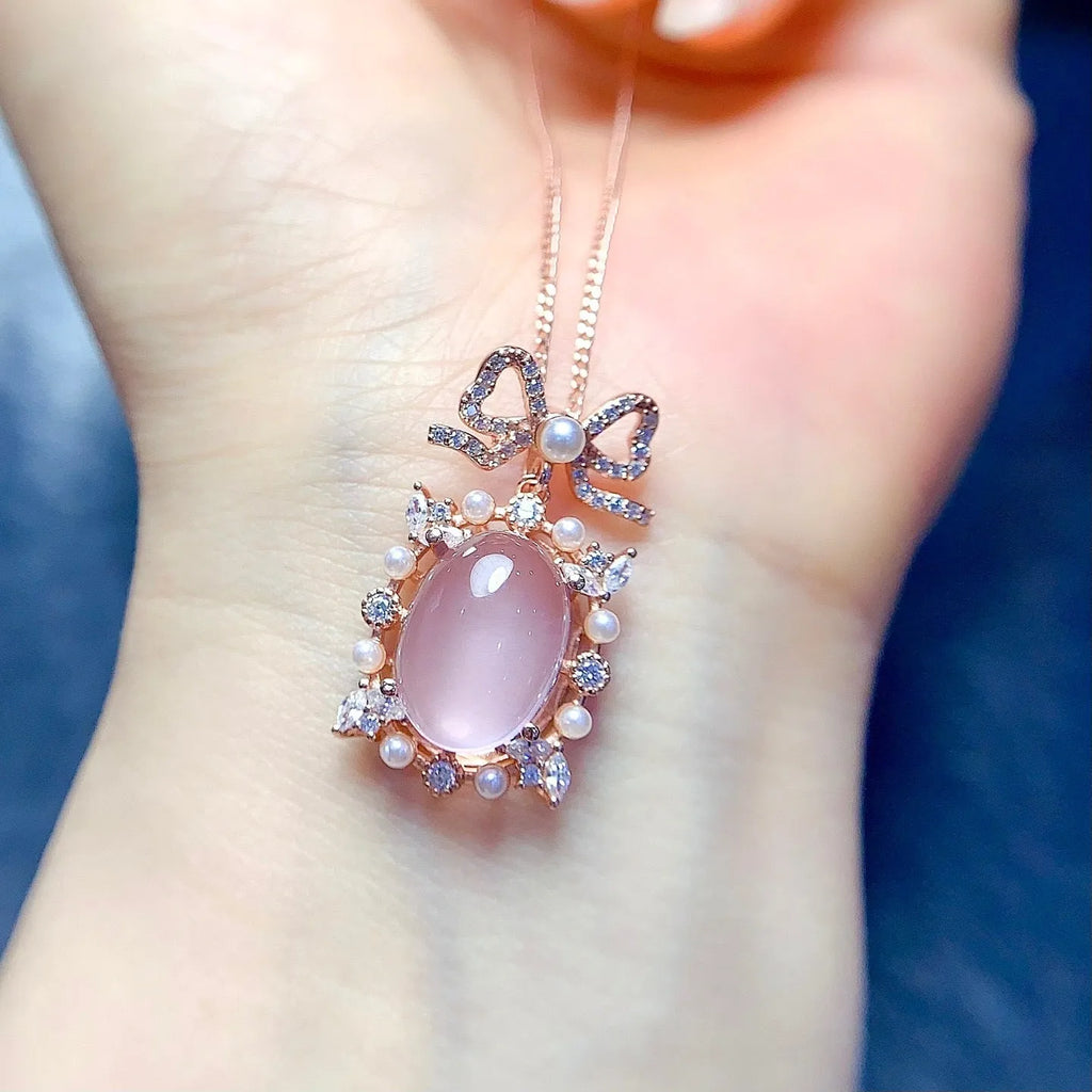 Pink crystal rose quartz pendant with rose gold plated geometric setting on alloy necklace