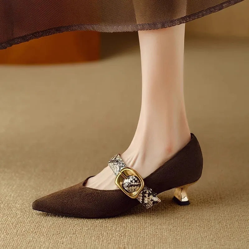 Black women's pointed toe stiletto high heels with a buckle fastening across the instep.