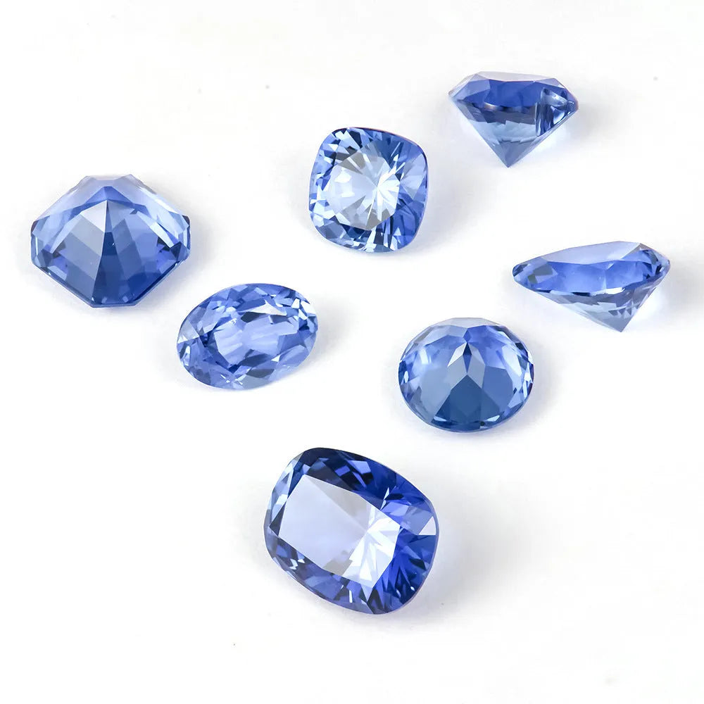 A royal blue loose gemstone with a precision cut, shown against a neutral background.