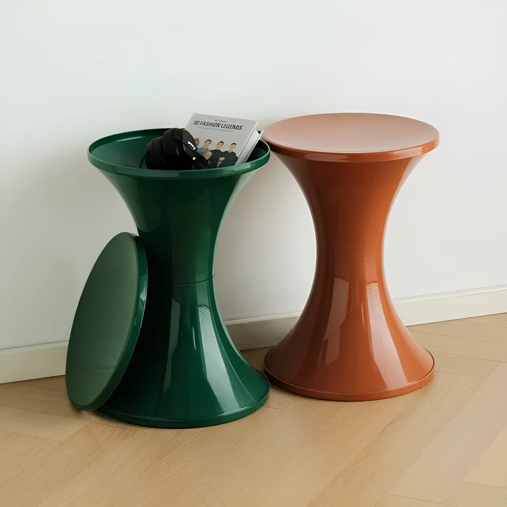 Green plastic hourglass style shoe changing stool on a wooden floor