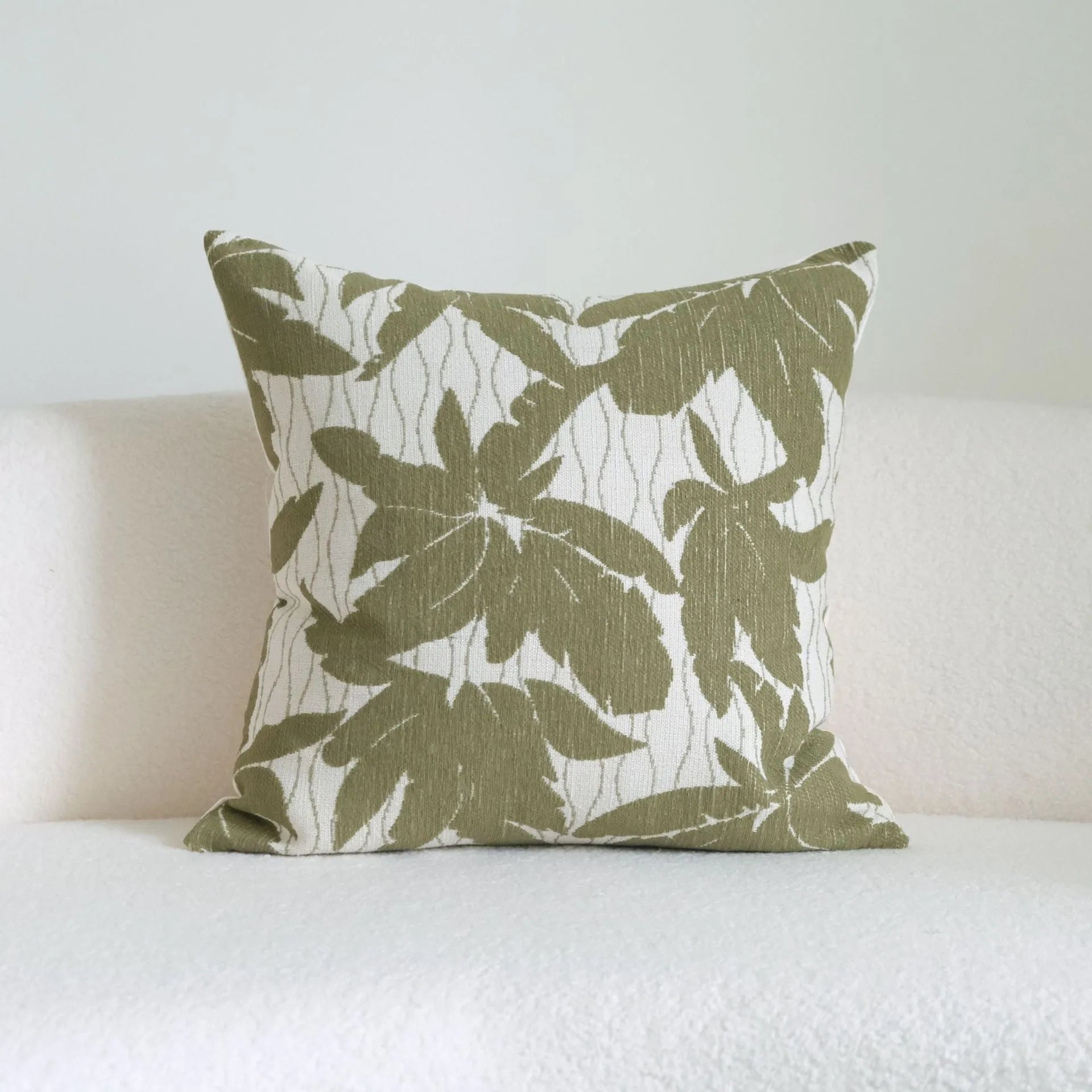 Green striped and botanical patterned cotton linen decorative pillow with tassel detail.