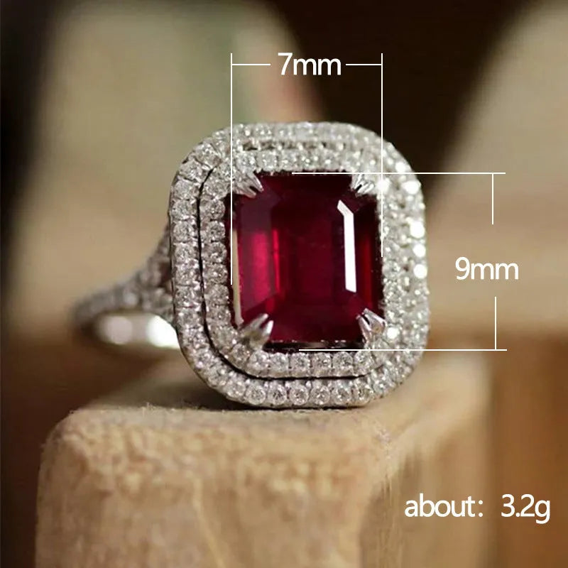 Geometric square copper women's ring with a red rhinestone, shown on a finger.