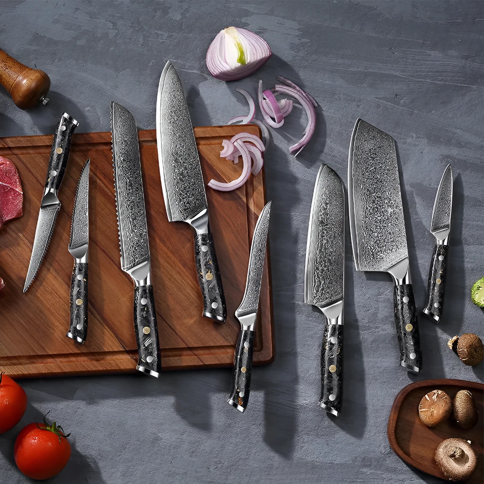 Eight-piece Damascus steel kitchen knife set with fishbone pattern, showing chef, utility, boning, steak, and fruit knives.