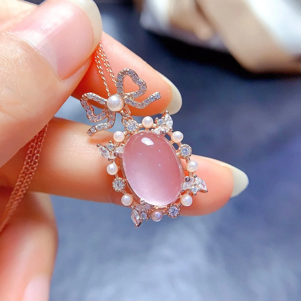 Pink crystal rose quartz pendant with rose gold plated geometric setting on alloy necklace