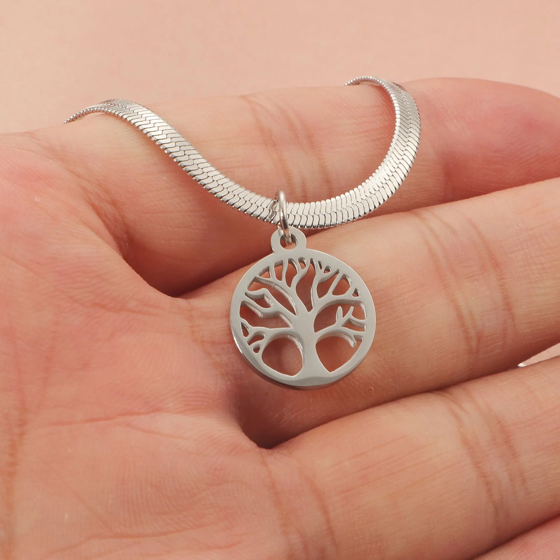 Stainless steel lucky tree necklace on snake bones chain, shown in gold and steel colour finishes.