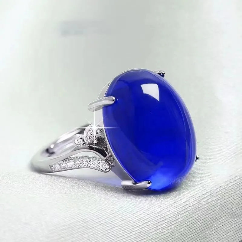 Geometric ethnic-style adjustable ring with a sapphire element in alloy, shown in multiple colours.