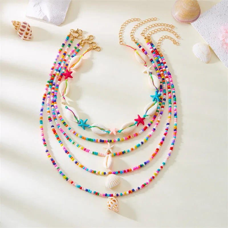 Women's multi-layer necklace set with starfish, shell and conch bead pendants in blue