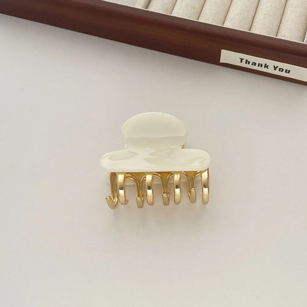 Dopamine retro acetate hair barrette with a metal grip in a medium size, shown in beige colour.